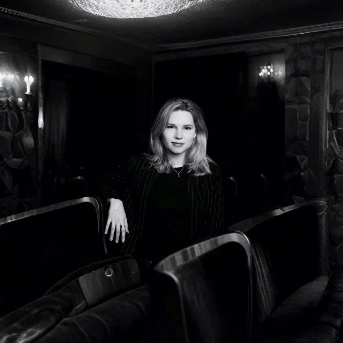 Black and white portrait among theatre seats