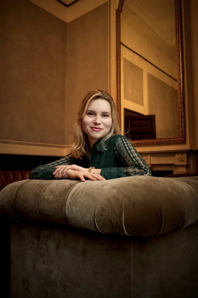 Portrait, seated indoors, natural light